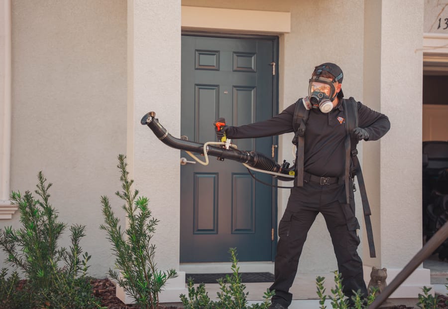 Taps technician applying pest control at a Riverview, FL home’s front entry