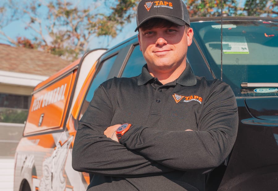 Taps pest control technician beside the service truck in Riverview, FL