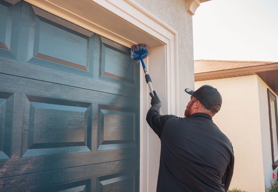 Taps technician de-webbing a Tampa, FL home for spider control