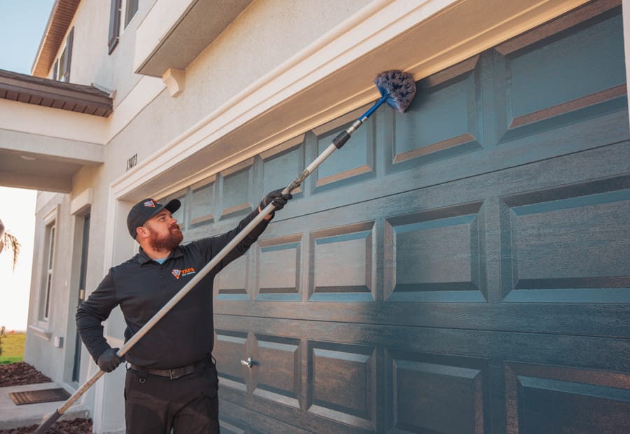 Taps technician clearing webs and pests from a Tampa, FL home exterior