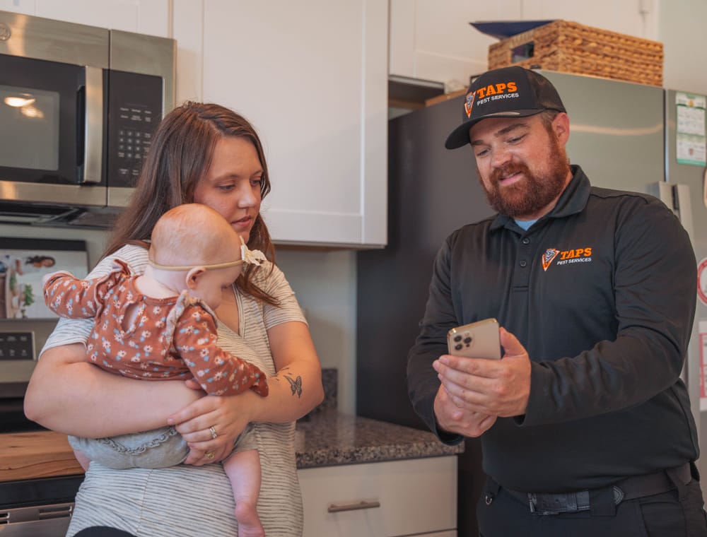 Taps Pest Services technician with a local family — pet- and family-safe pest control in Riverview, FL